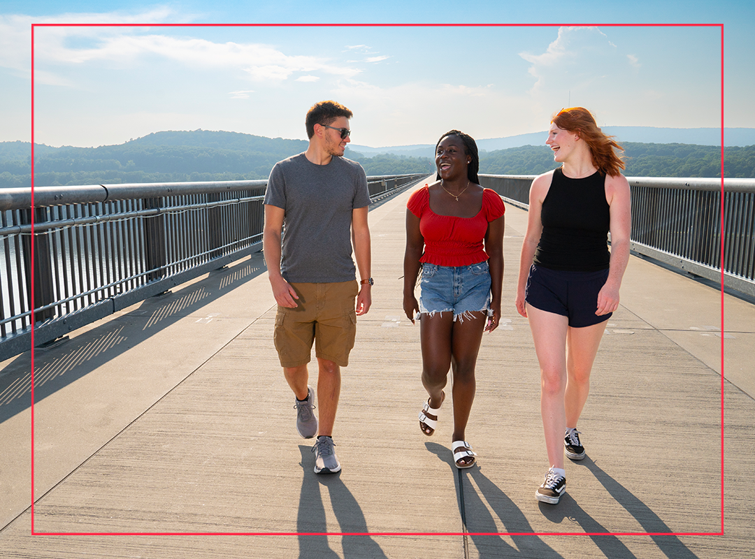Students walking on a bridge over the Hudson River.